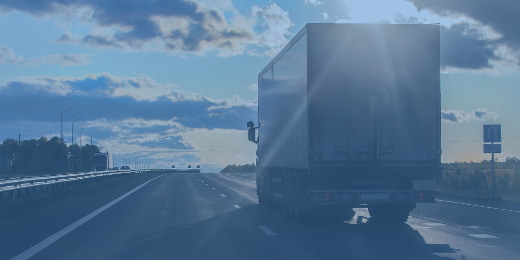 Freight truck driving down road